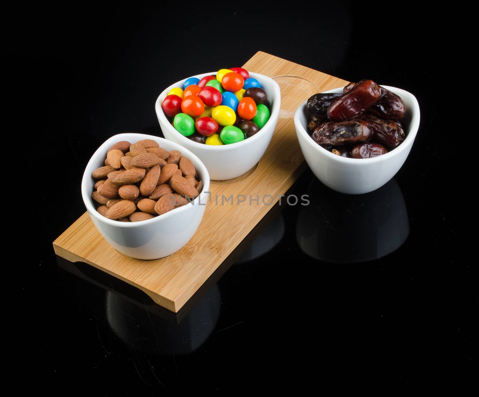 almond, chocolate and date on a background.