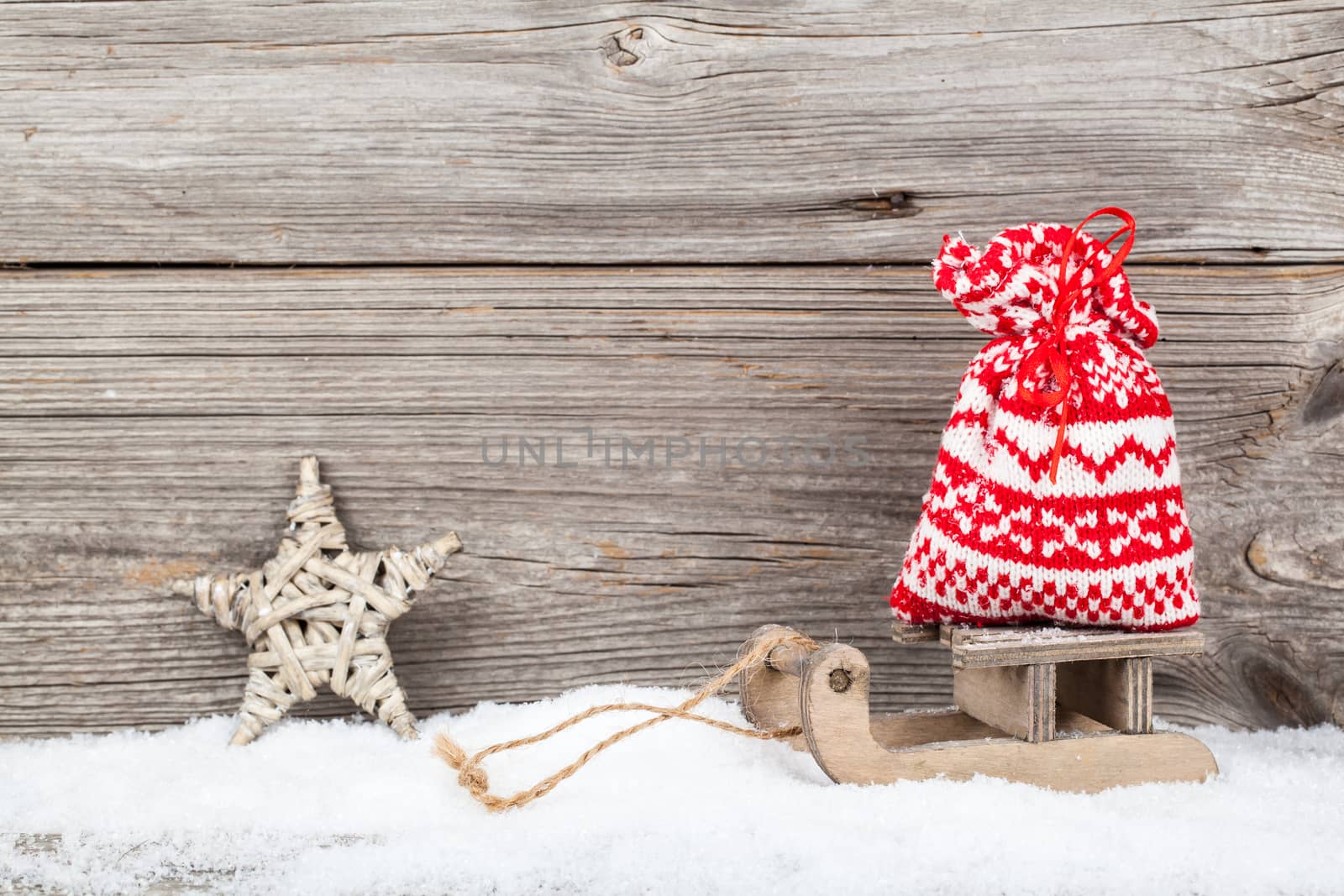 Christmas decoration over snow, wooden background