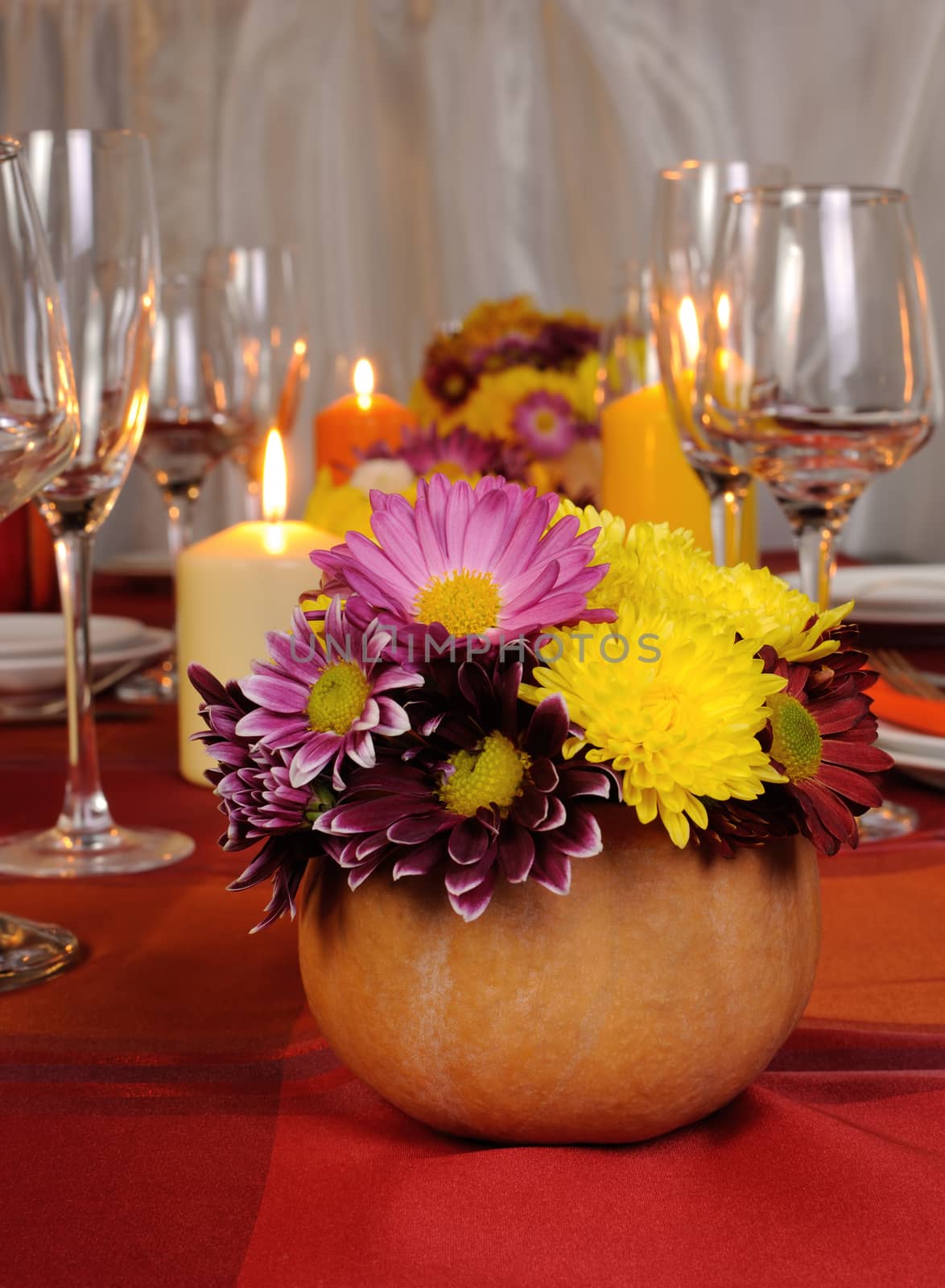Autumn flowers in a vase on the table with pumpkin by Apolonia