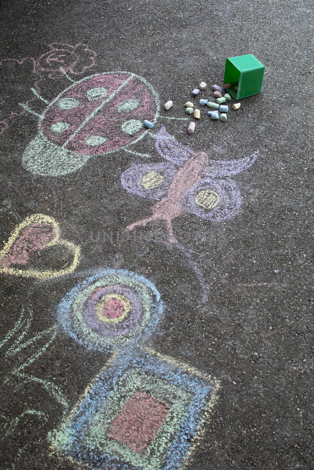 Kids were drawing on an asphalt.