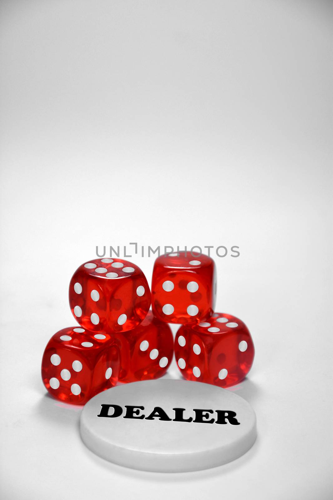 Poker chips, dices and a dealer button, isolated on white. Mainly used for poker..