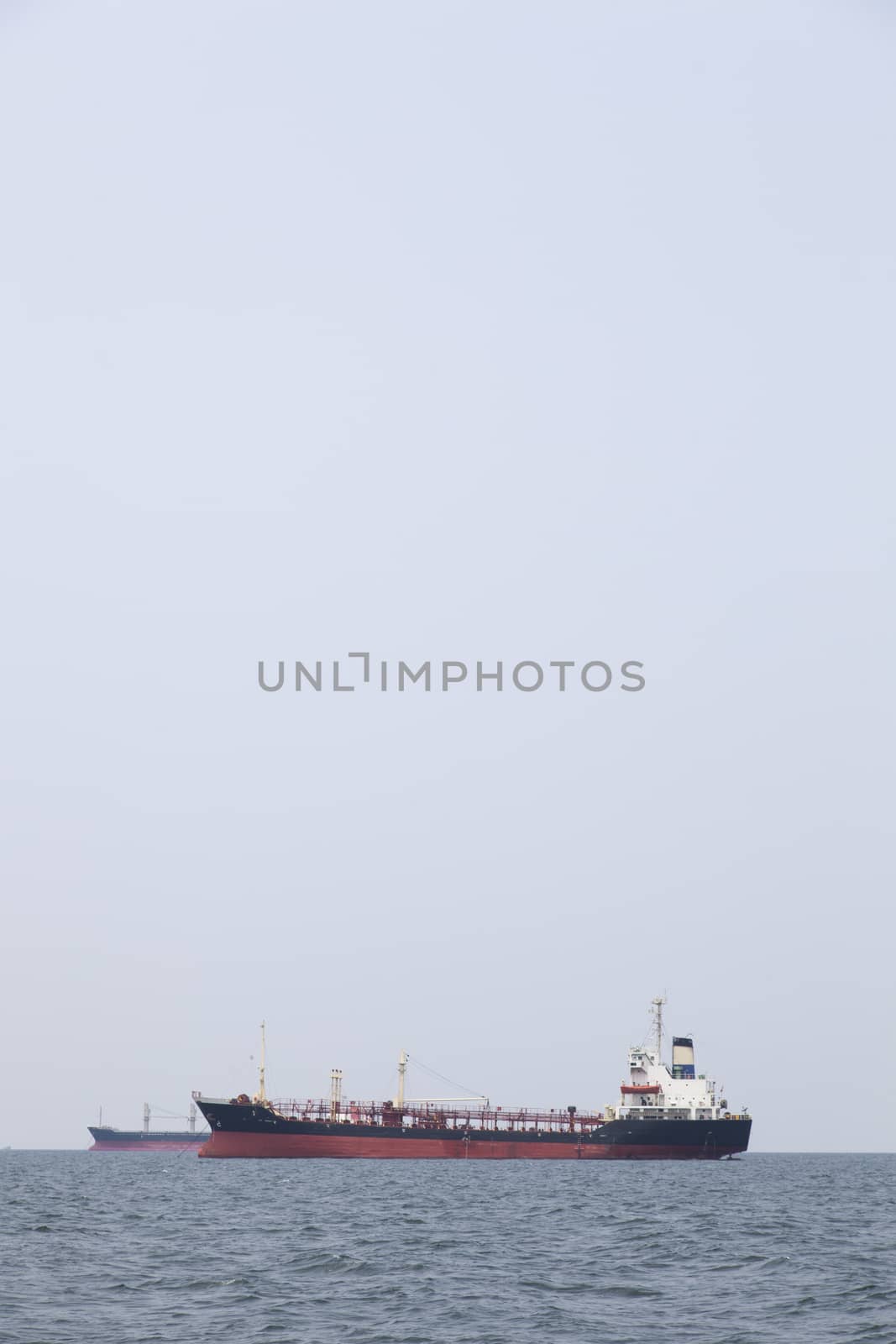 Large cargo ship Boats moored in the sea to make sense compared to the coast.