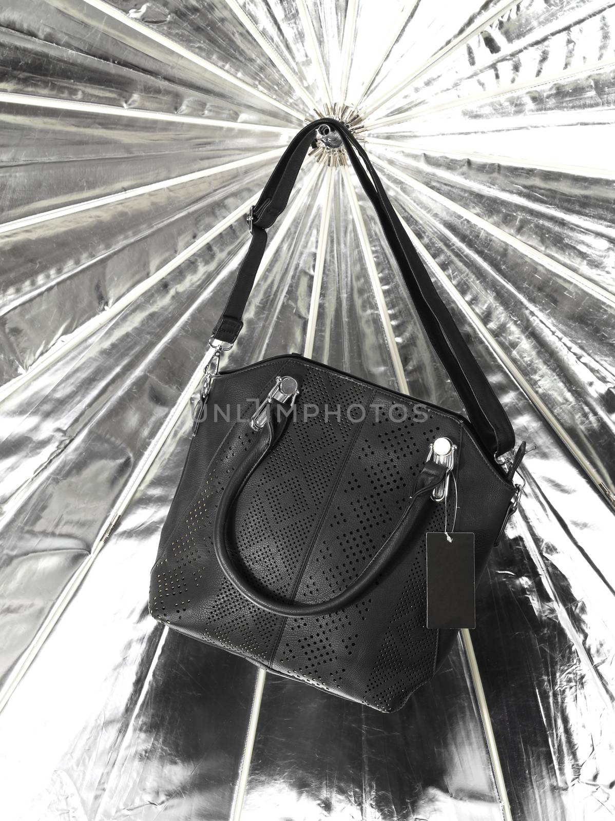 Black leather bag over shiny bckground
