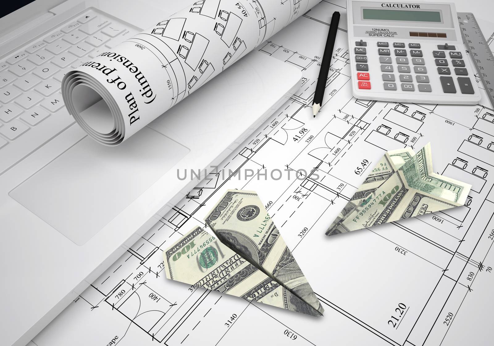 Paper airplanes of dollars lying on architectural drawings. Laptop and tools are close by. Concept of building business