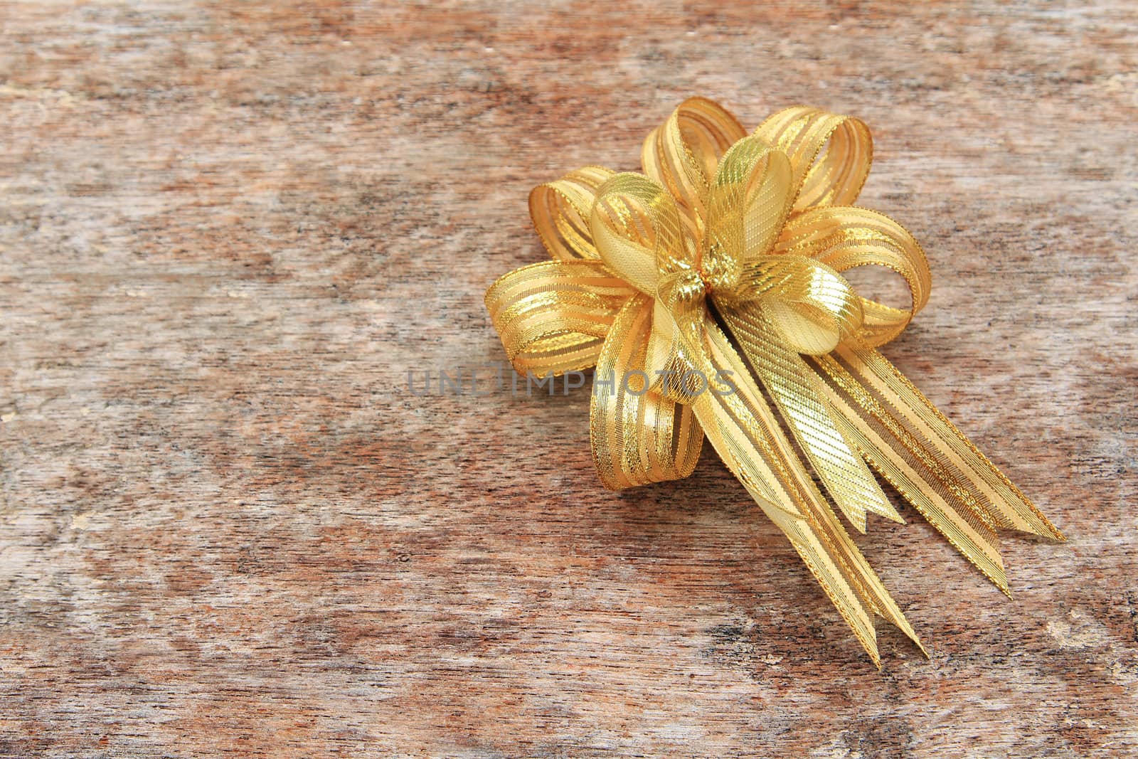 Golden Ribbon on old wood background