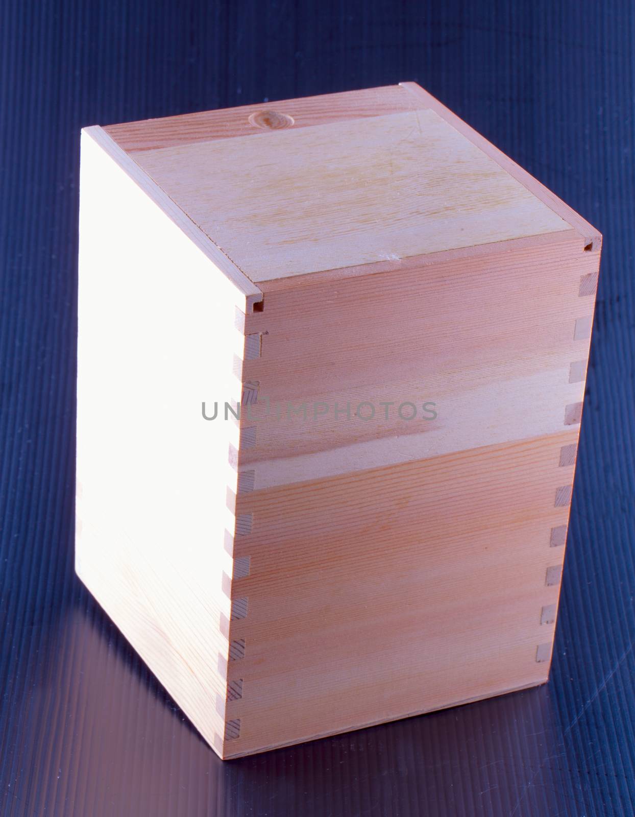 Wooden box over black background, vertical image