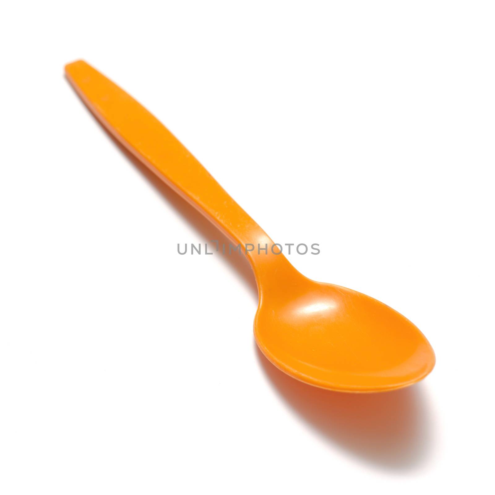 orange plastic spoon on a white background