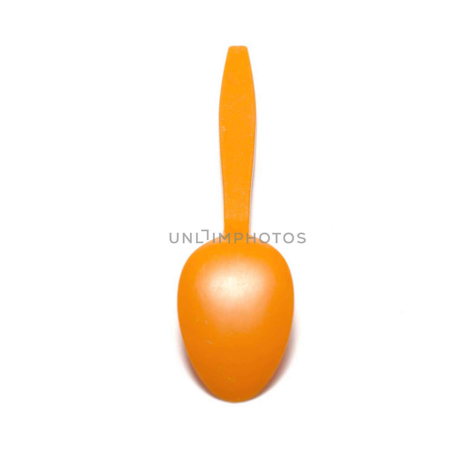 orange plastic spoon on a white background