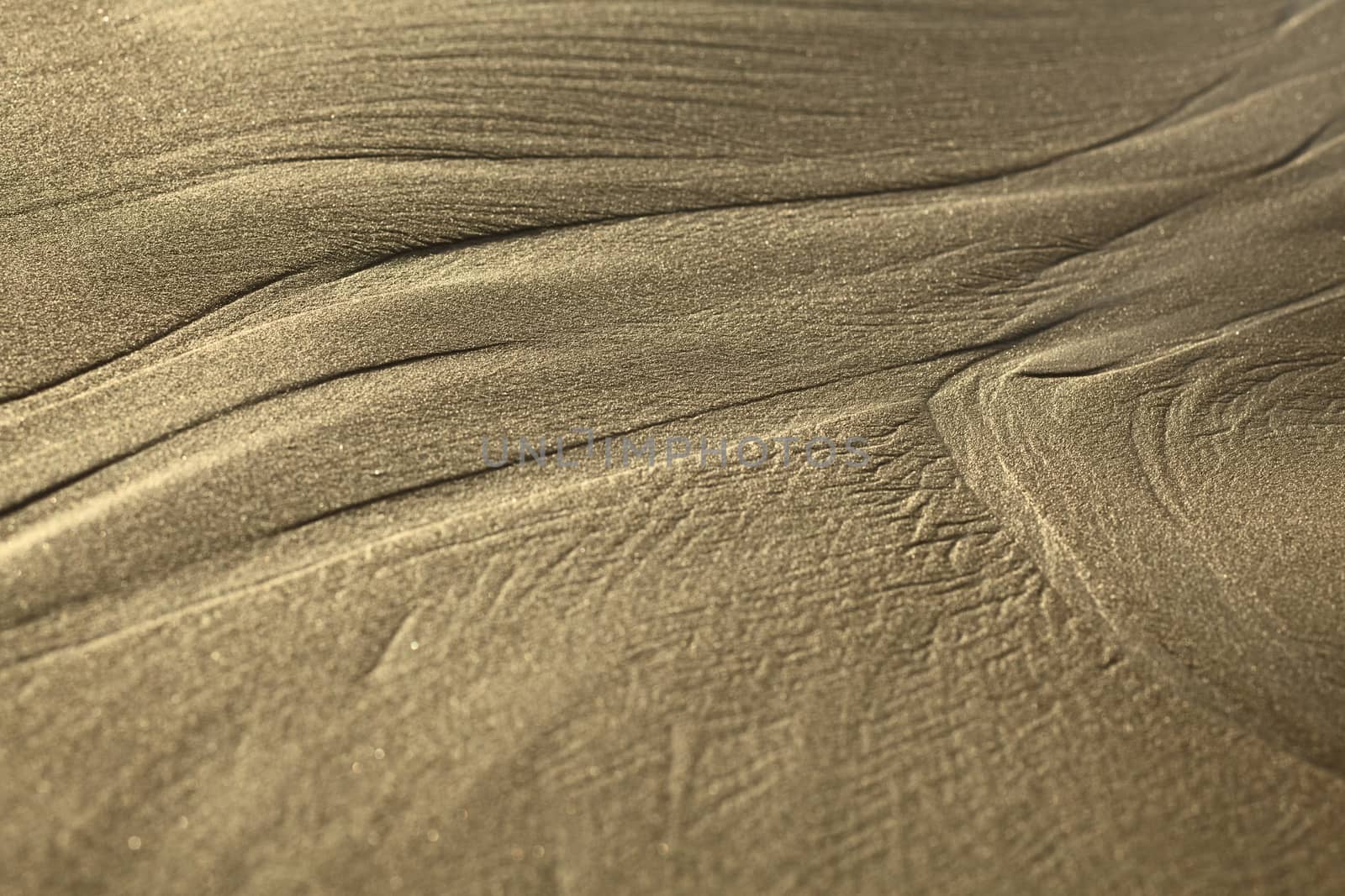 Lines formed by the water on sandy beach in the small town of Mancora in Northern Peru (Selective Focus, Focus where one line branches out into two) 