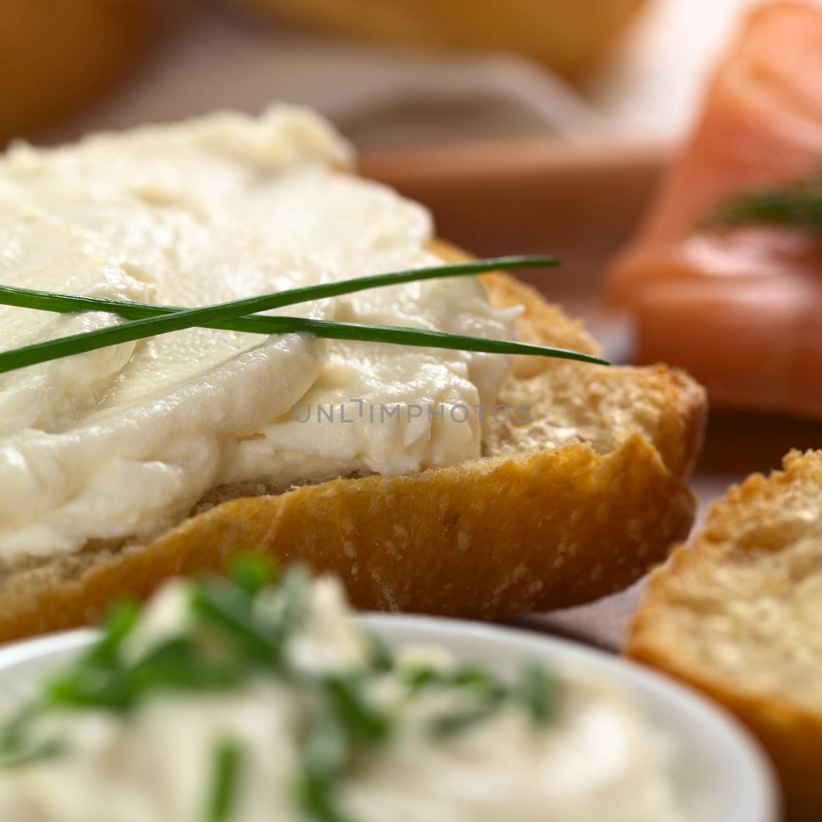 Cream cheese canape garnished with chives (Selective Focus, Focus on the front of the cream cheese on the bun)