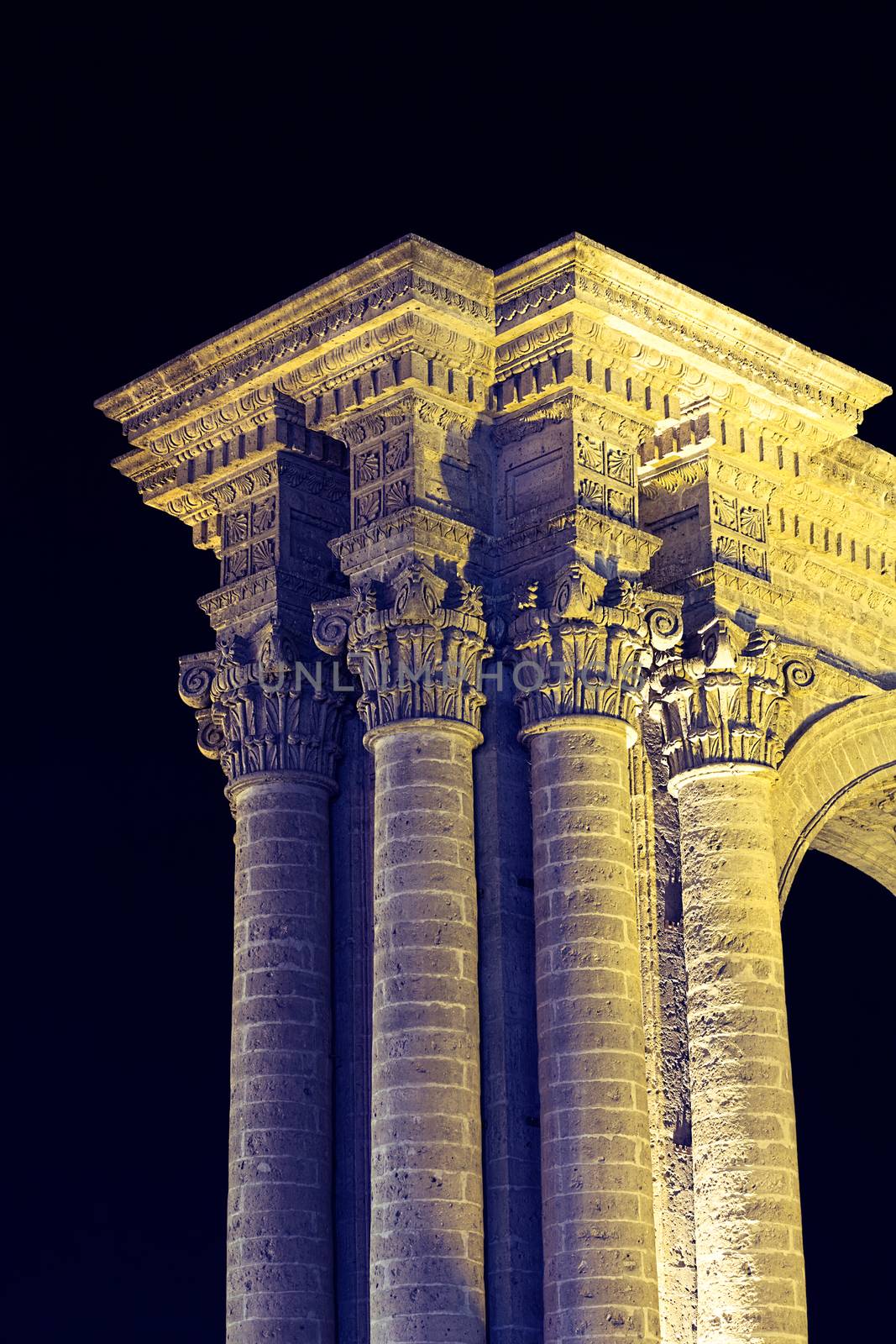 Column and arch at the side of the Basilica Cathedral of Arequipa lit at night. The city center of Arequipa, Peru is an UNESCO World Cultural Heritage Site. 
