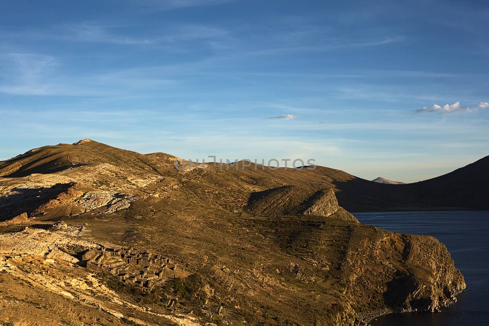 The Northern part of Isla del Sol (Island of the Sun), a popular tourist destination on Lake Titicaca, Bolivia before sunset. In the left lower corner the Tiwanaku-Inca ruin Chinkana is visible.