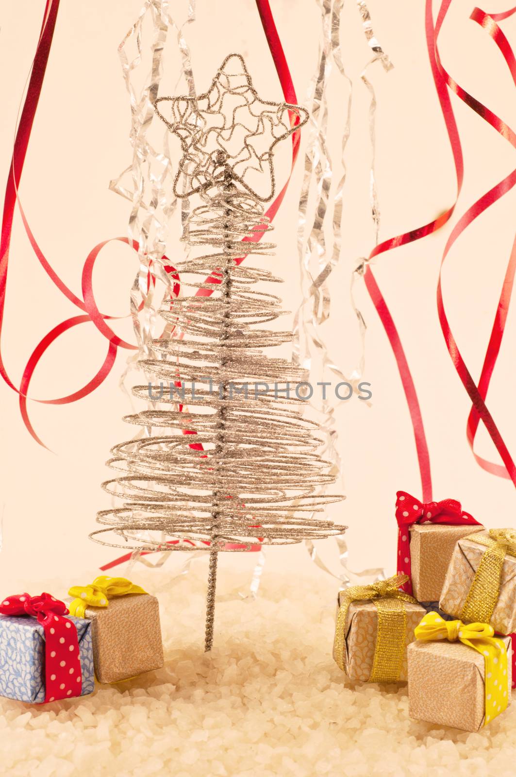 Christmas tree with presents on snow and colored fiefs