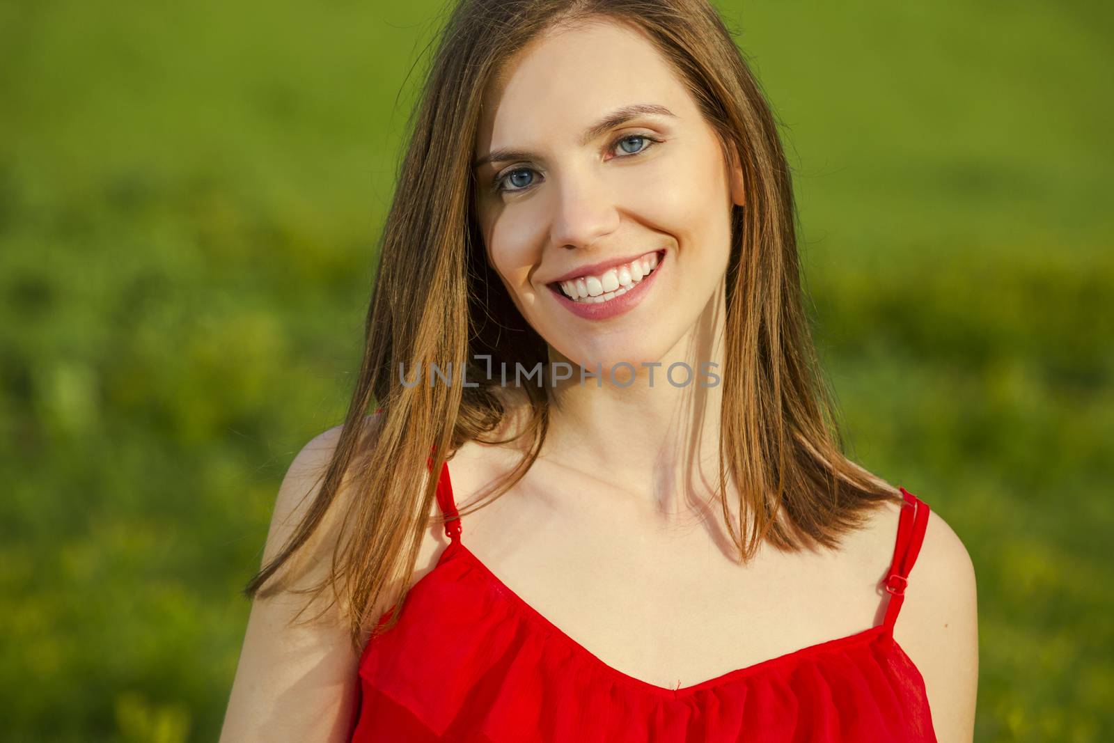 Young beautiful woman in a red dress smiling