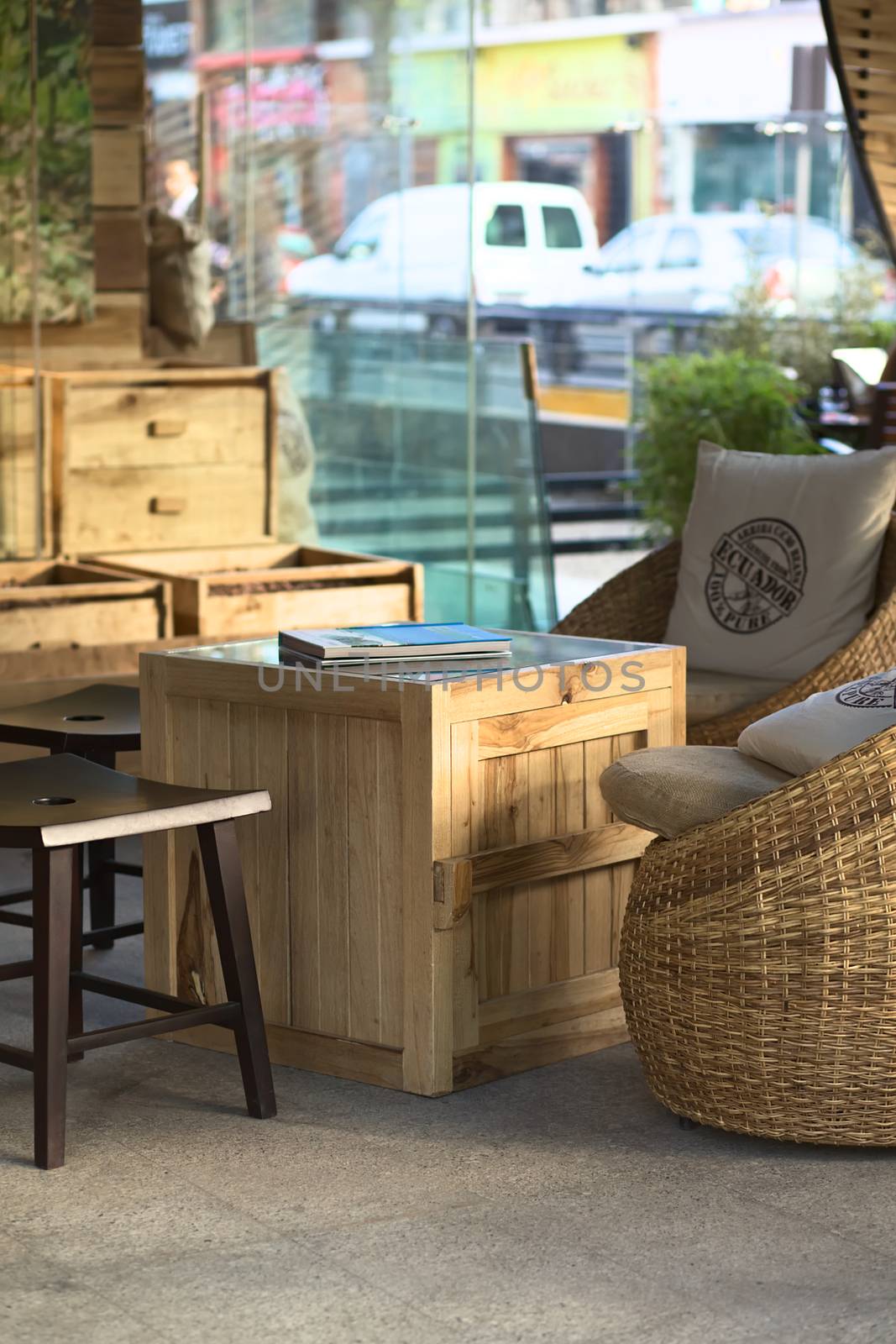 QUITO, ECUADOR - AUGUST 8, 2014: Small table with seats inside the Republica del Cacao shop and cafe on August 8, 2014 in Quito, Ecuador. The shop is located at the corner of the streets Reina Victoria and Joaquin Pinto in the tourist district La Mariscal (Selective Focus, Focus on the front of the table)