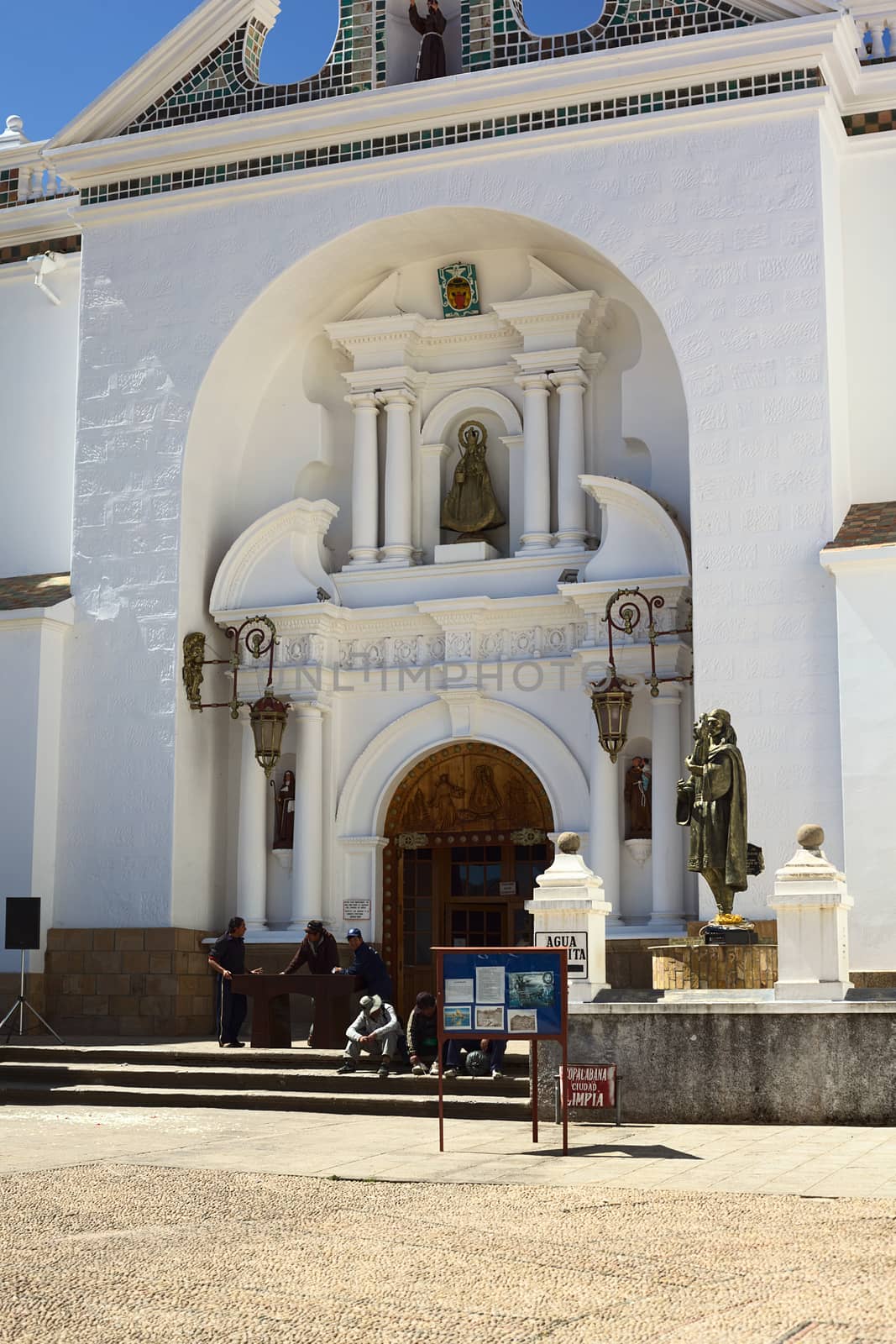 COPACABANA, BOLIVIA - OCTOBER 18, 2014: Unidentified people sitting and standing outside the entrance of the Basilica of Our Lady of Copacabana in the small tourist town along the Titicaca Lake on October 18, 2014 in Copacabana, Bolivia 