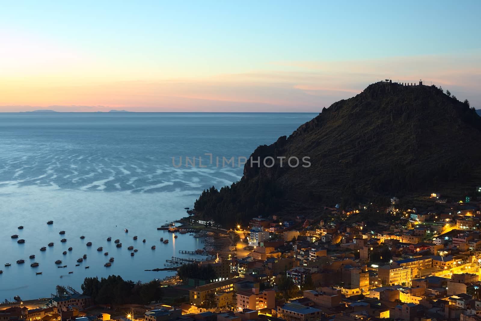 COPACABANA, BOLIVIA - OCTOBER 24, 2014: View shortly after sunset over the small touristy town of Copacabana and Lake Titicaca photographed from Kesanani hill on October 24, 2014 in Copacabana, Bolivia