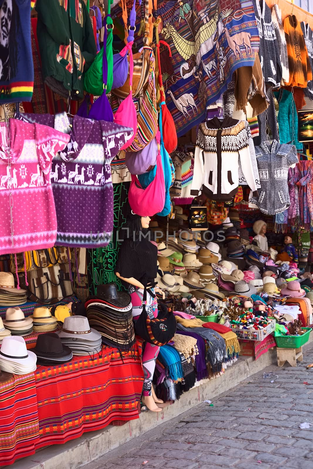 COPACABANA, BOLIVIA - OCTOBER 19, 2014: Hats, sweaters, scarves and bags at souvenir and handicraft shop in the small tourist town on the shore of Lake Titicaca on October 19, 2014 in Copacabana, Bolivia (Selective Focus, Focus on the front of the image)