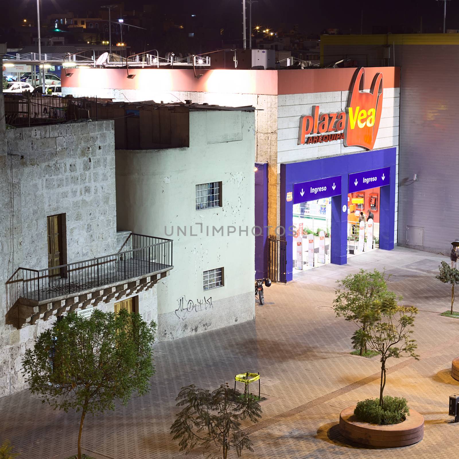 AREQUIPA, PERU - AUGUST 14, 2014: Entrance of Plaza Vea supermarket on La Marina street in the evening on August 14, 2014 in Arequipa, Peru. Plaza Vea is the largest supermarket chain in Peru and is part of Supermercados Peruanos S.A.