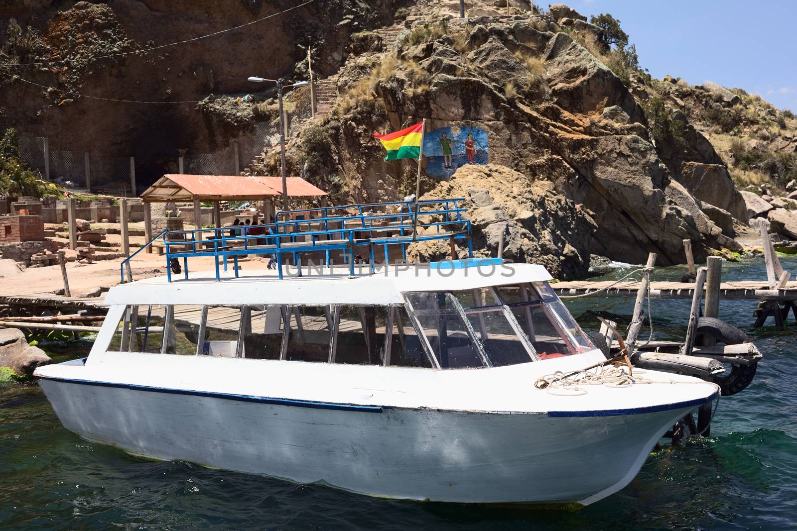 COPACABANA, BOLIVIA - OCTOBER 17, 2014: Tour boat anchoring at wooden jetty at Boca del Sapo (Frog's Mouth) close to the tourist town of Copacabana at Lake Titicaca on October 17, 2014 in Copacabana, Bolivia