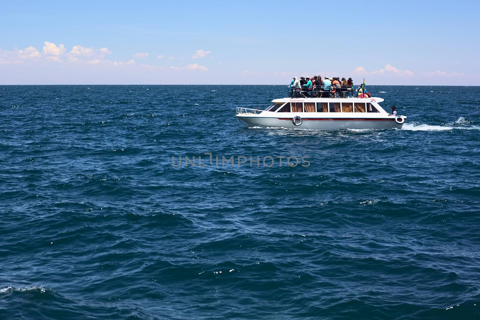 COPACABANA, BOLIVIA - OCTOBER 17, 2014: Tour boat full of tourists on Lake Titicaca on October 17, 2014 close to the tourist town of Copacabana, Bolivia. Such tour boats transport people from Copacabana to Isla del Sol (Sun Island) and back. 