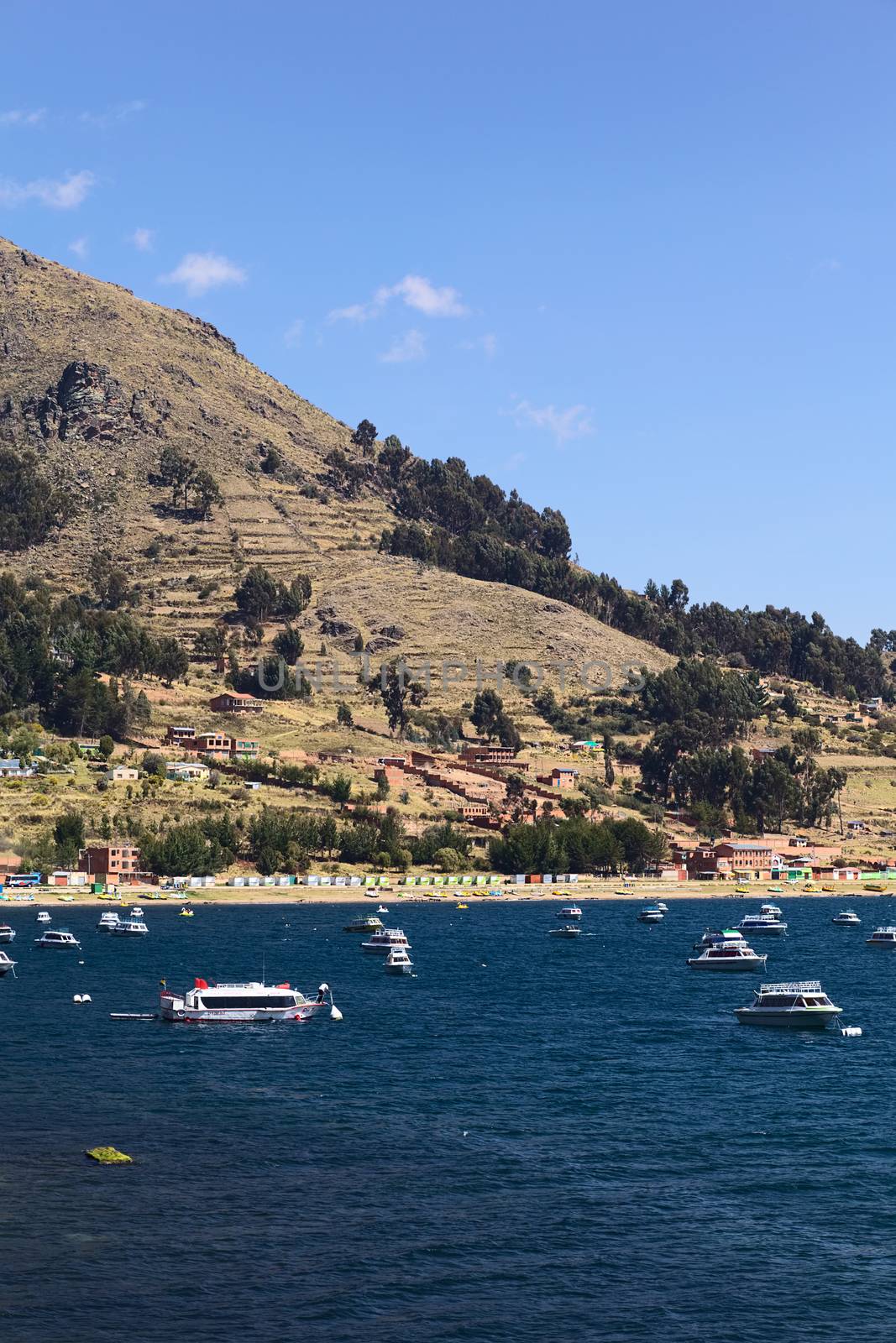 COPACABANA, BOLIVIA - OCTOBER 17, 2014: Motor boats anchoring in the bay of the small tourist town on the shore of Lake Titicaca on October 17, 2014 in Copacabana, Bolivia. Copacabana is the starting point for tours and transportation to Isla del Sol (Sun Island).