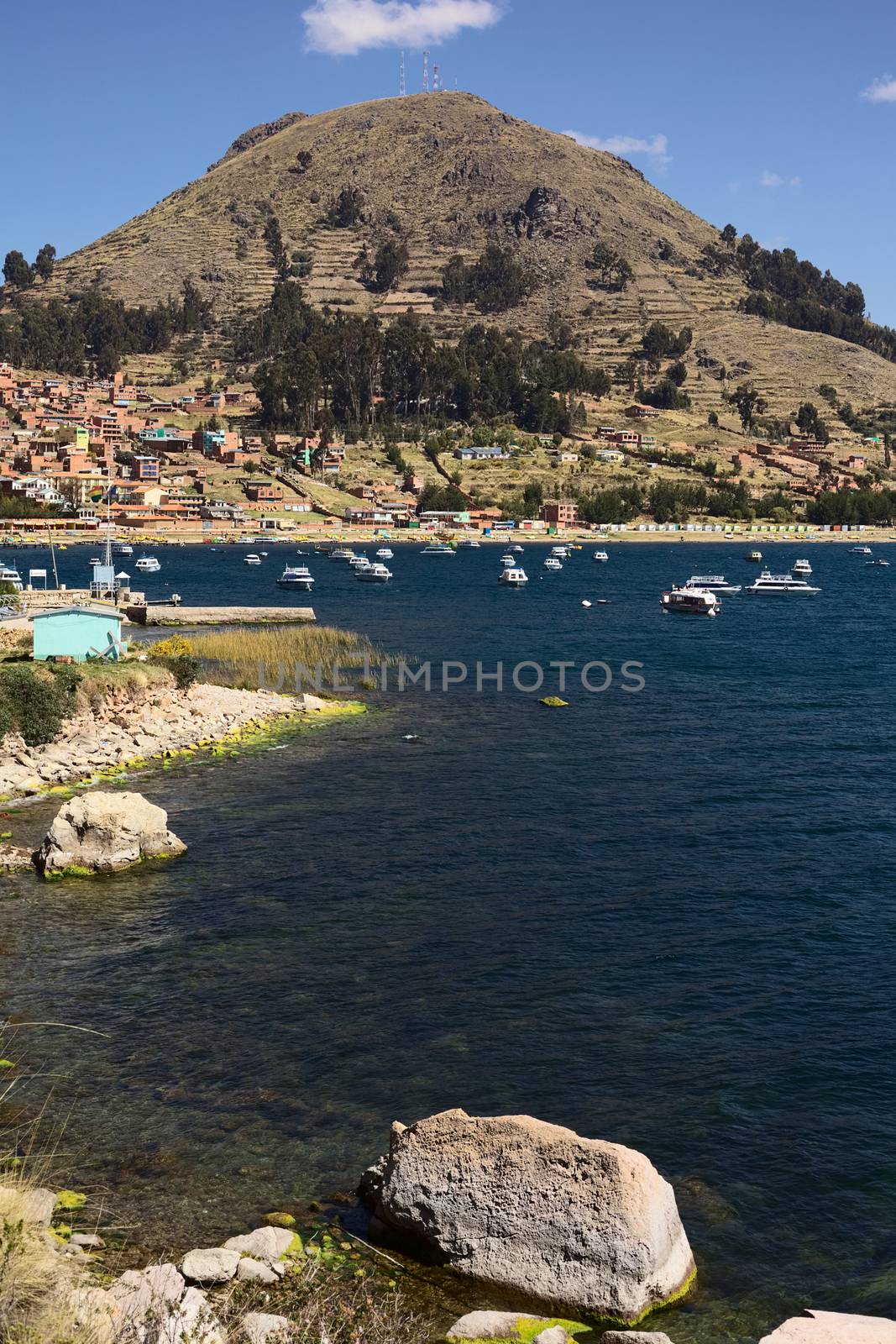 COPACABANA, BOLIVIA - OCTOBER 17, 2014: Motor boats anchoring in the bay of the small tourist town on the shore of Lake Titicaca on October 17, 2014 in Copacabana, Bolivia. Copacabana is the starting point for tours and transportation to Isla del Sol (Sun Island).