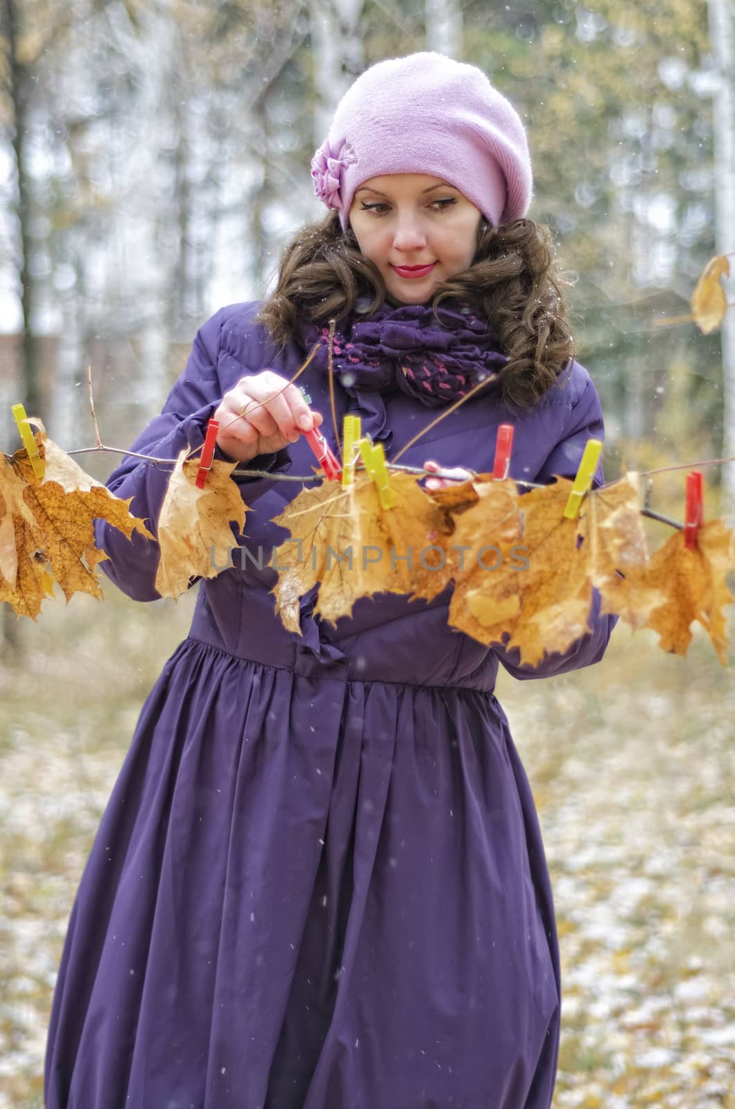 Girl hanging autumn leaves on the tree by Gaina