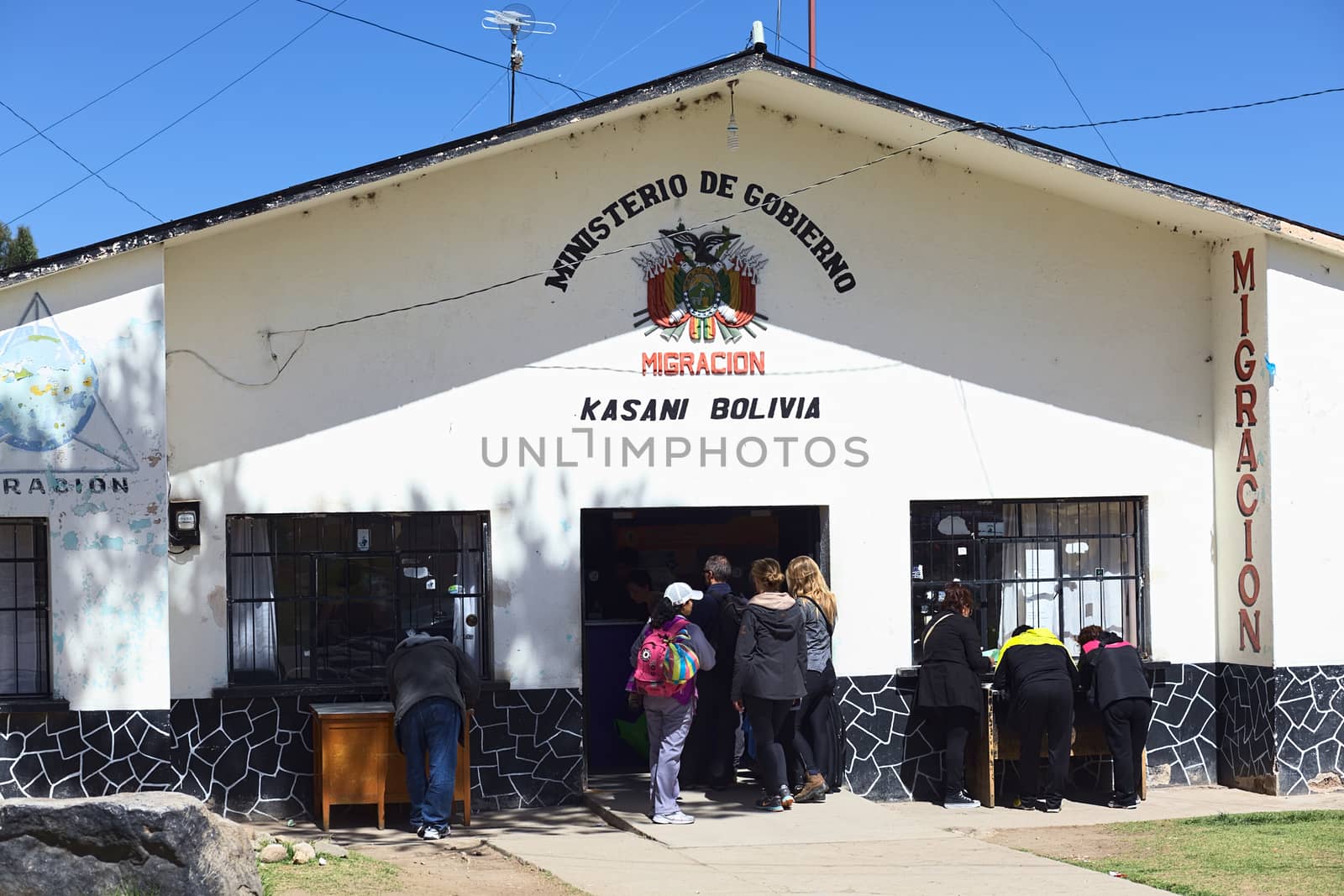 KASANI, BOLIVIA - OCTOBER 10, 2014: Unidentified people standing in line in front of the migration office on the Bolivian side of the Peruvian-Bolivian border on October 10, 2014 in Kasani, Bolivia