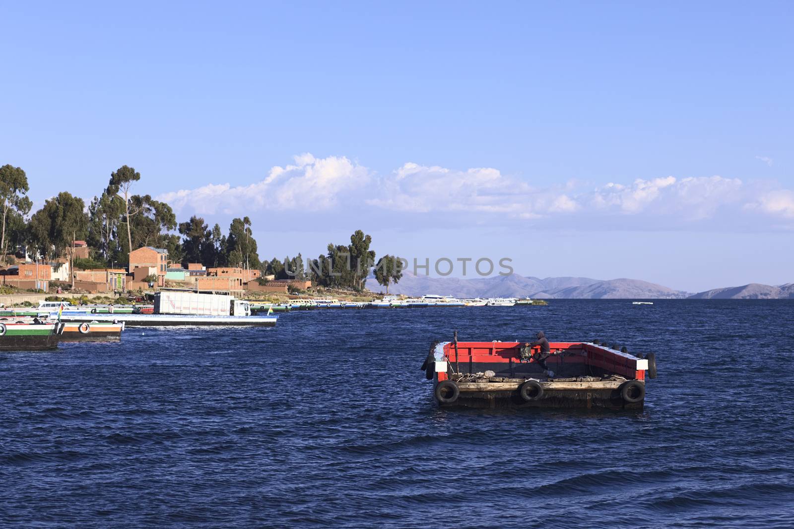 TIQUINA, BOLIVIA - OCTOBER 16, 2014: Empty wooden ferry on Lake Titicaca at the Strait of Tiquina on October 16, 2014 in San Pablo de Tiquina, Bolivia. Vehicles are being transported over on these wooden ferries, passengers and pedestrians have to use small motorboats to cross.