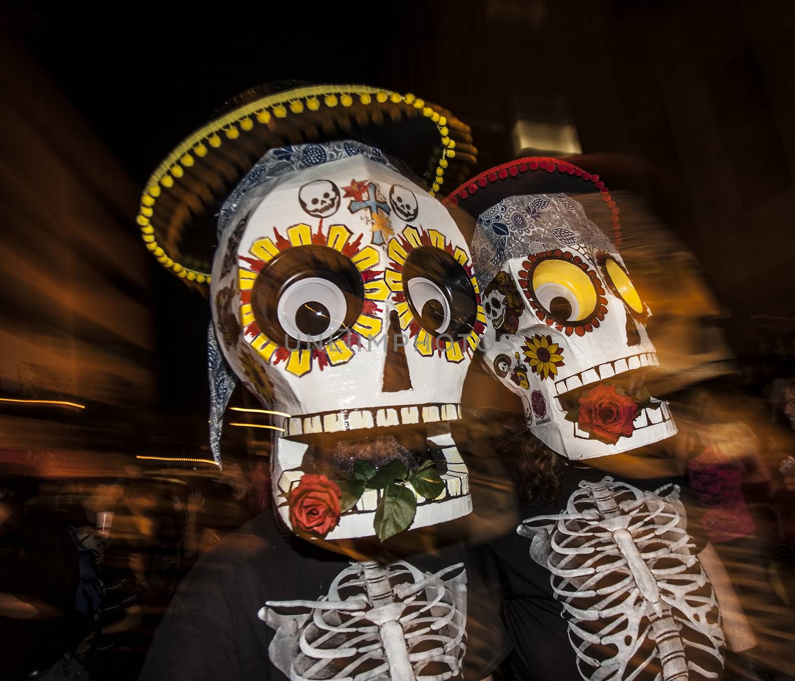 People with Large Masks in Dia De Los Muertos Procession by Creatista