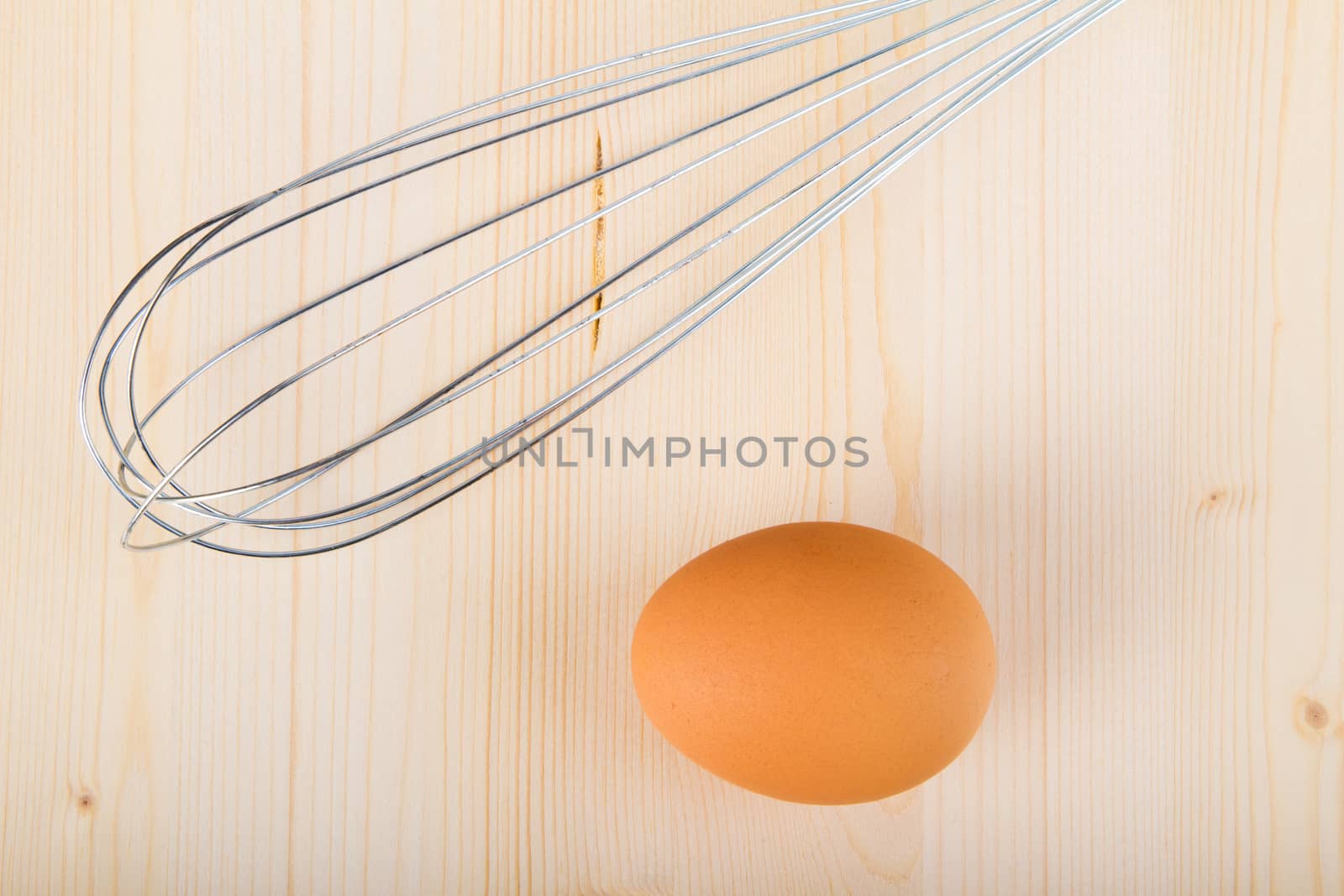 Fresh brown egg on a wooden table