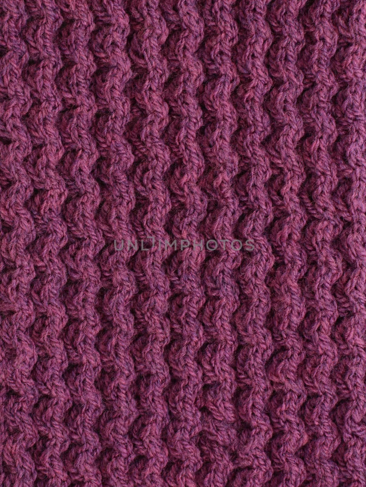 Purple cable knitting stitch as an abstract background texture