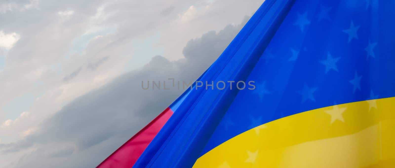 Ukrainian and American flags shine through each other