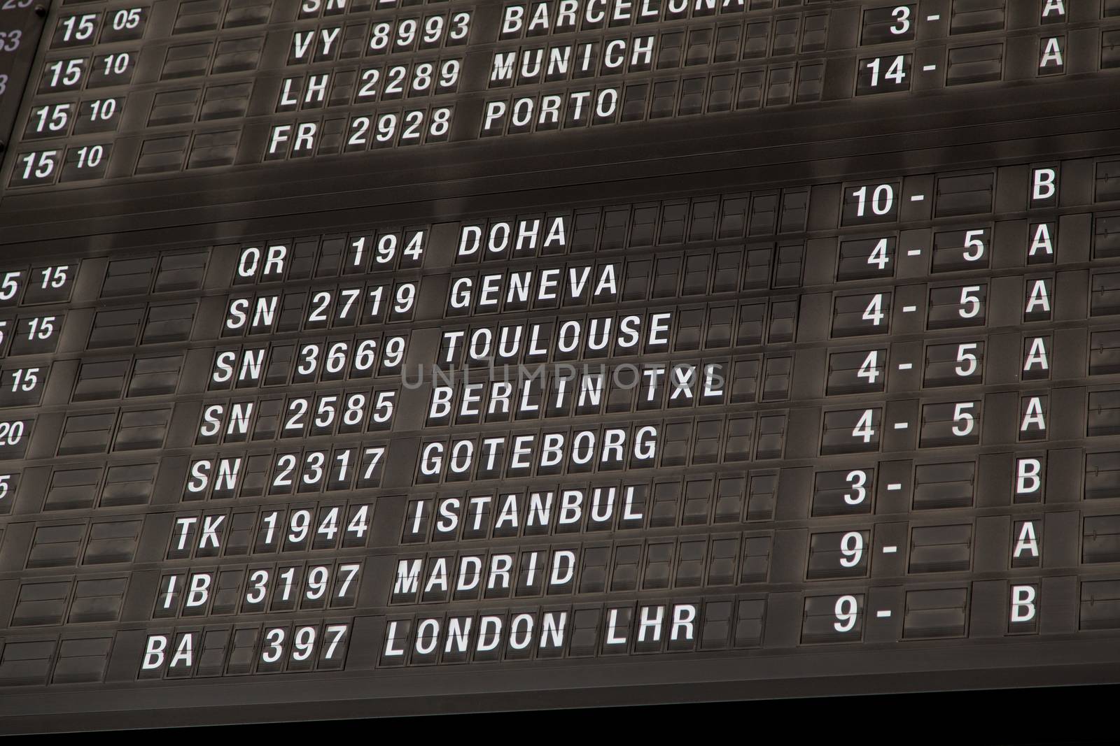 Airport departure board in terminal with flight information