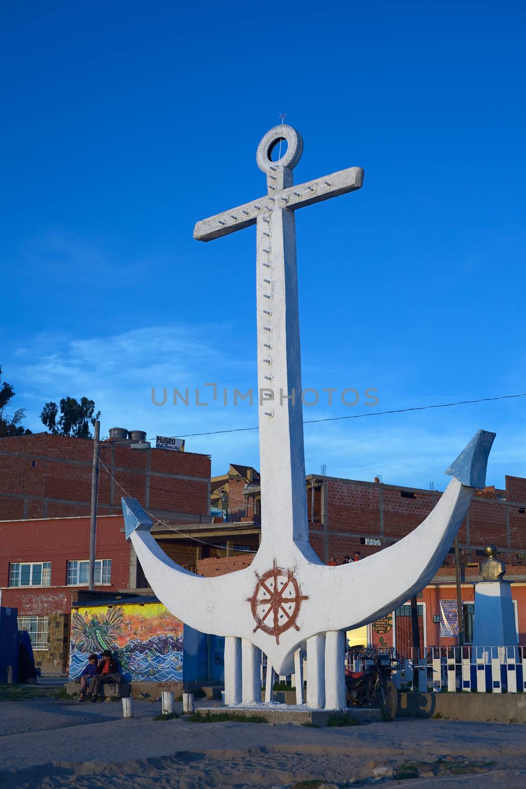 COPACABANA, BOLIVIA - OCTOBER 17, 2014: Anchor lit by the setting sun on the shore of Lake Titicaca in the harbor of the small tourist town on October 17, 2014 in Copacabana, Bolivia. Copacabana is the starting point for tours and transportation to the Isla del Sol (Sun Island).