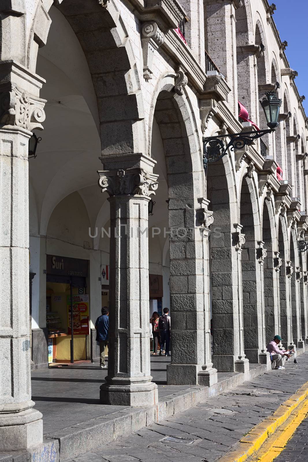 AREQUIPA, PERU - AUGUST 22, 2014: The archway of Paseo Portal de Flores on Plaza de Armas (main square) on August 22, 2014 in Arequipa, Peru. The city center of Arequipa is UNESCO World Cultural Heritage Site.  