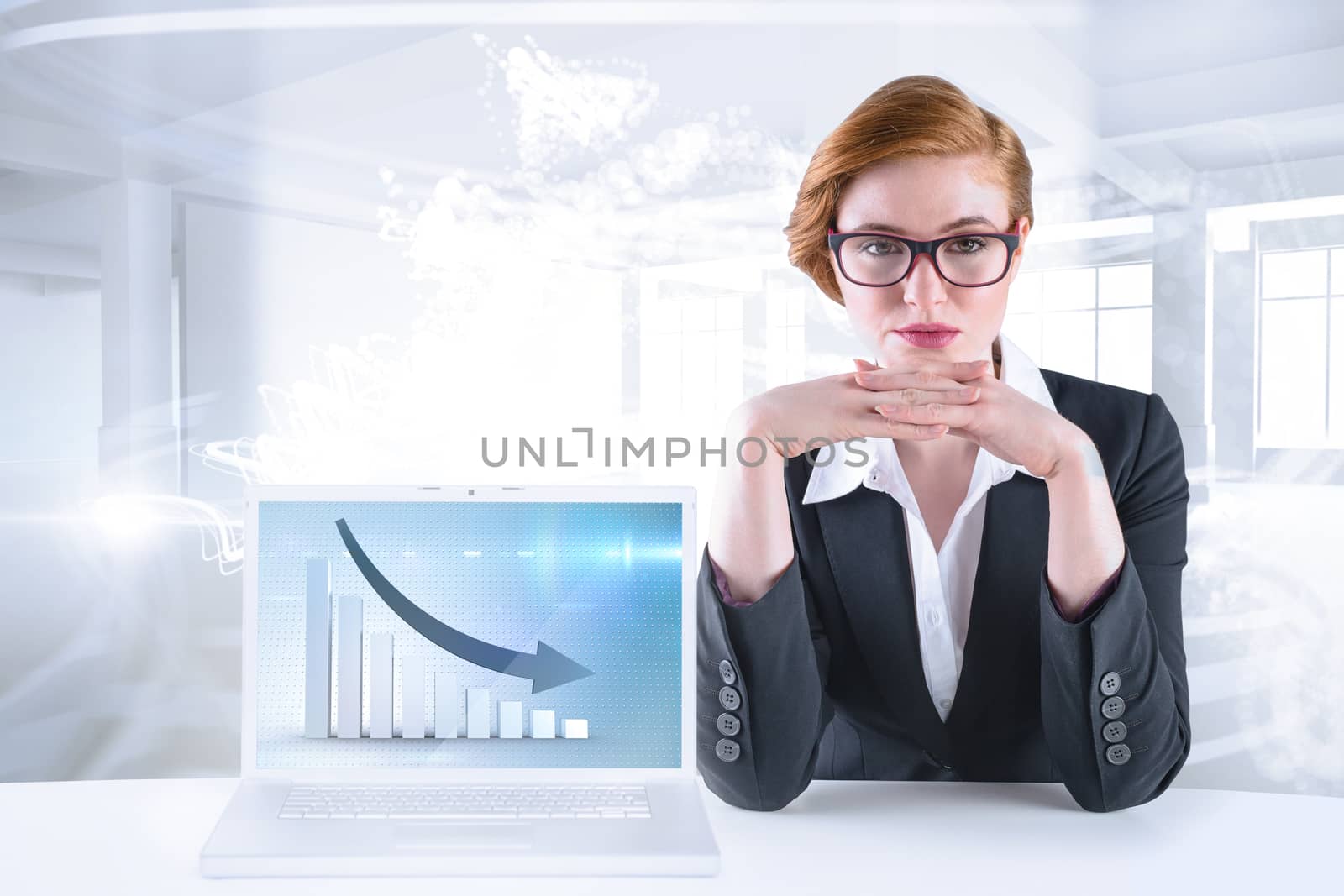 Redhead businesswoman sitting at desk against abstract white design in room