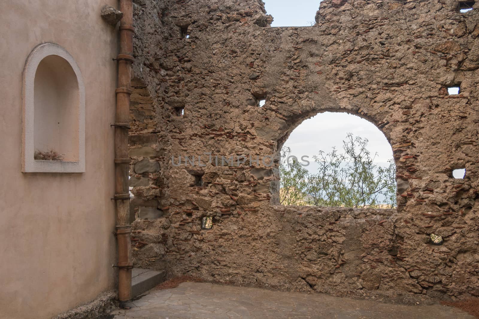 Ancient stone window that shows part of landscape