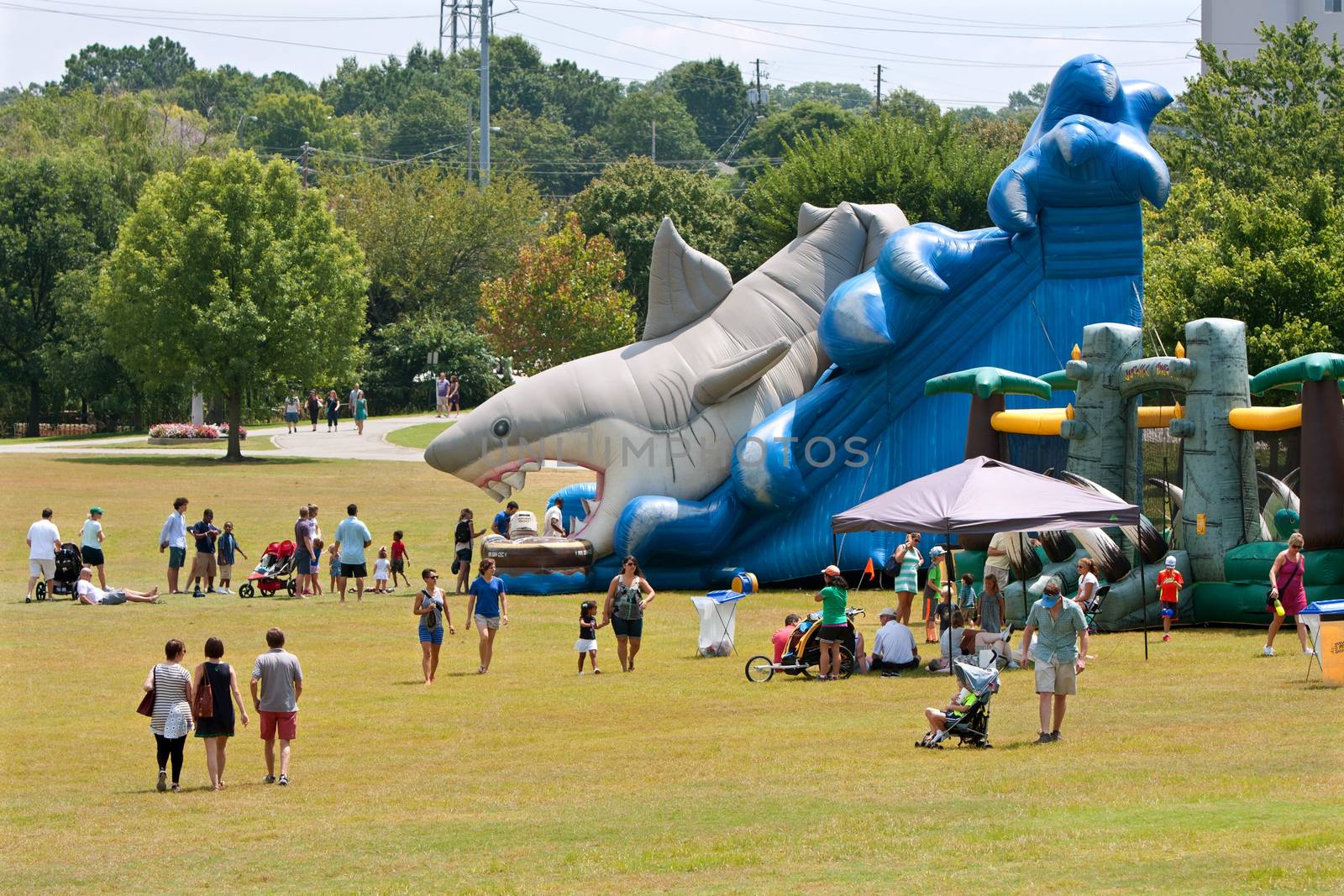 Families Enjoy A Giant Inflatable Shark Slide At Festival Playgr by BluIz60