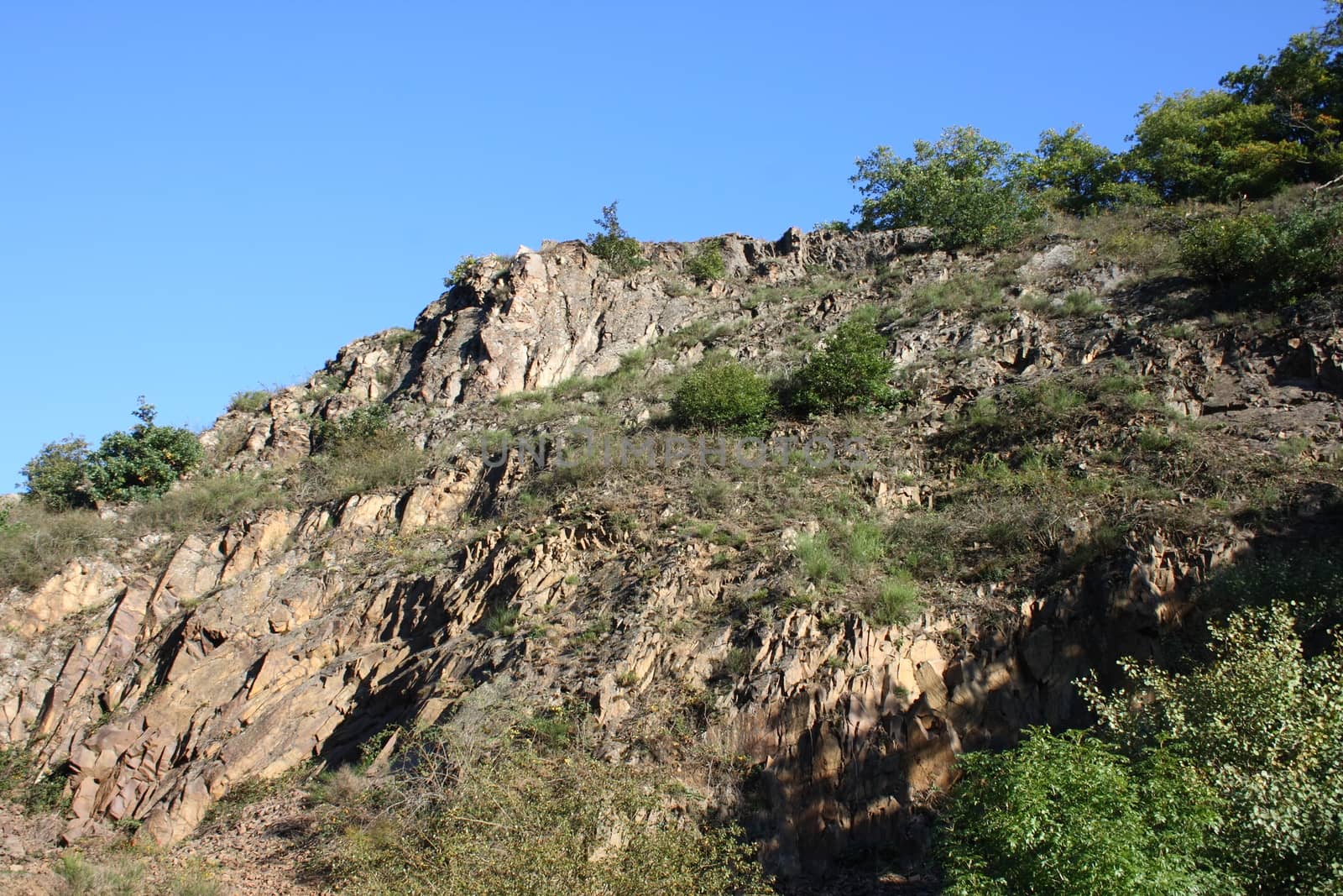 A landscape in the highlands, with rocks, trees and blue sky