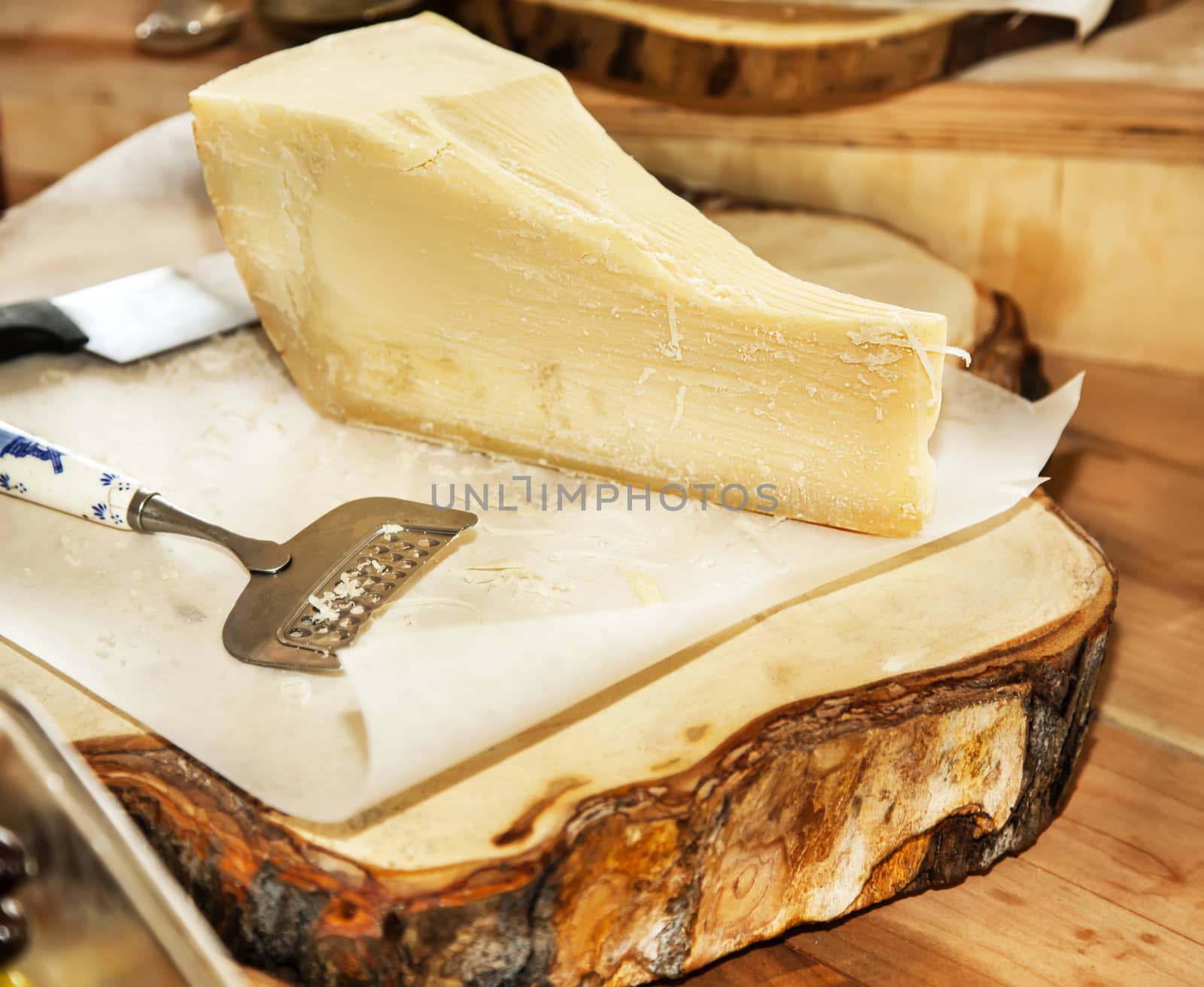 Parmesan cheese on a wooden plate by RawGroup