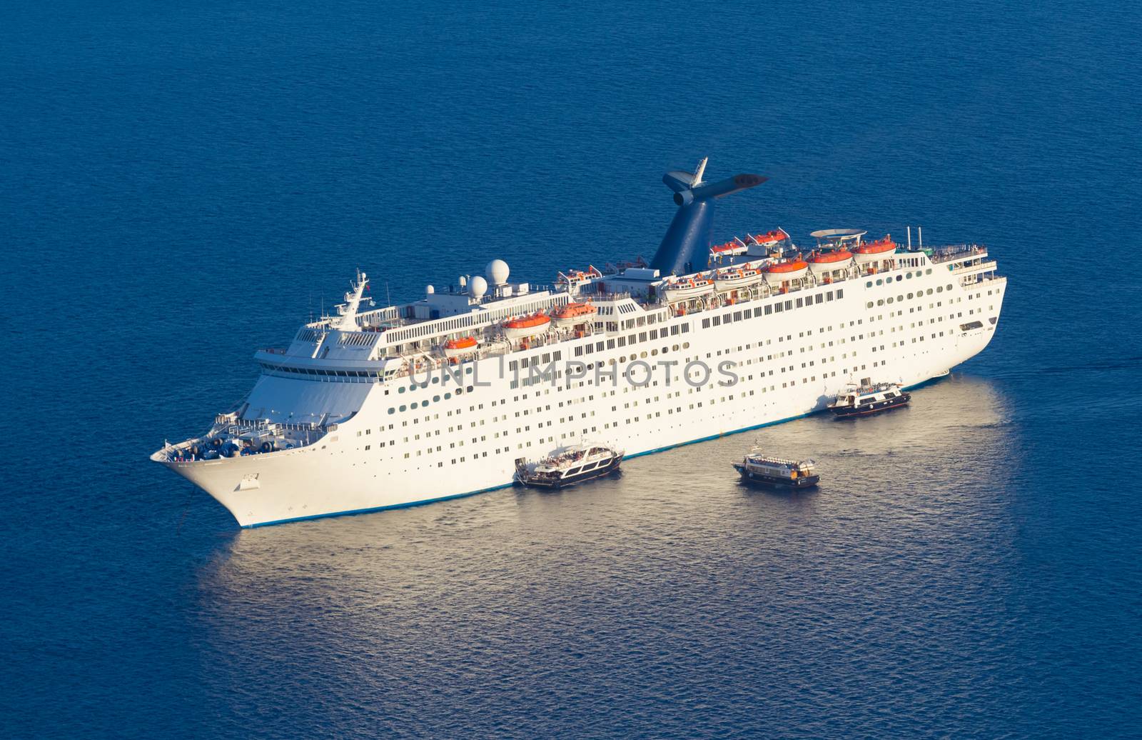 Luxury cruise ship sailing around Santorini island, Aegean sea in Greece.