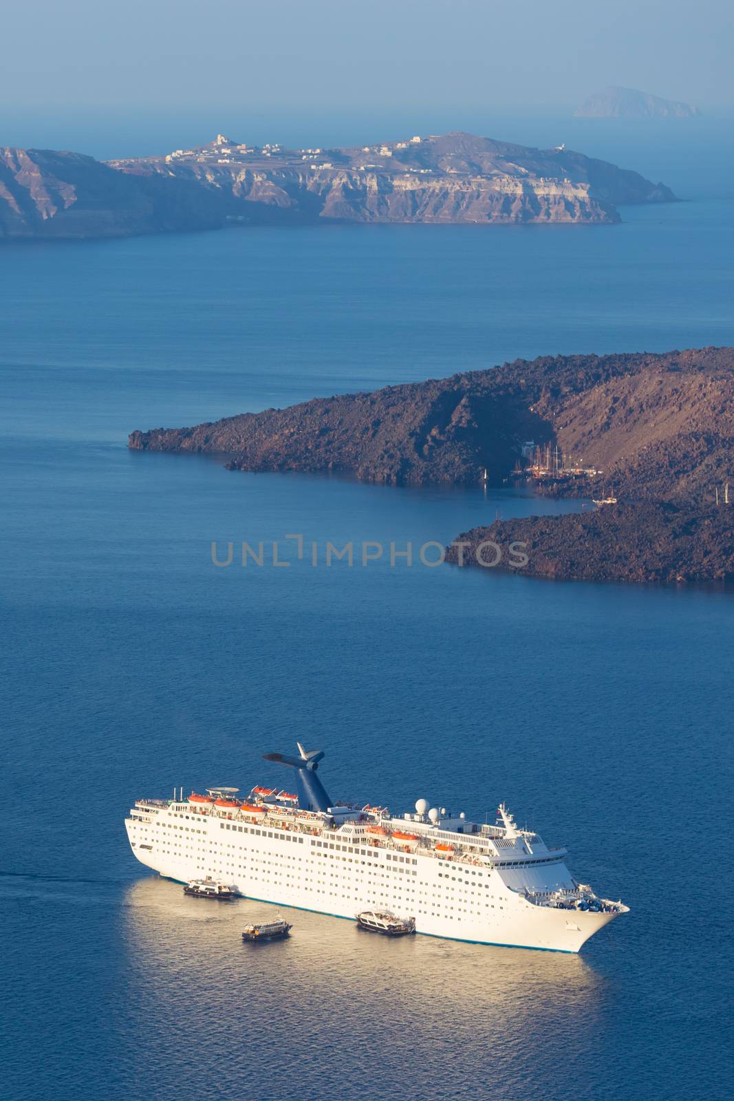 Luxury cruise ship sailing around Santorini island, Aegean sea in Greece.