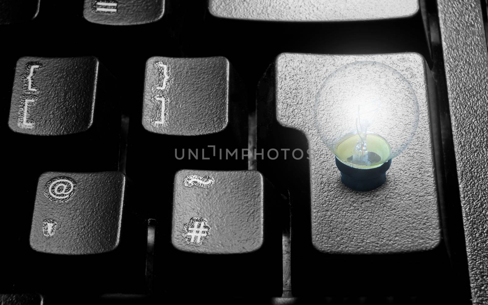 Illuminated light bulb linked to a computer enter key