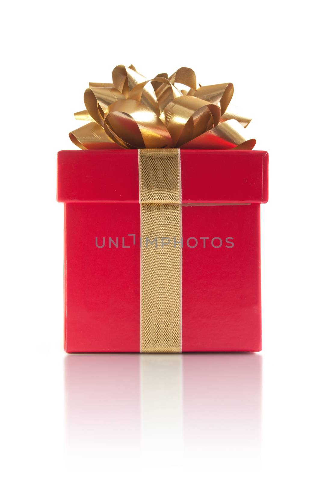 Red gift box with silk ribbon over a white background 