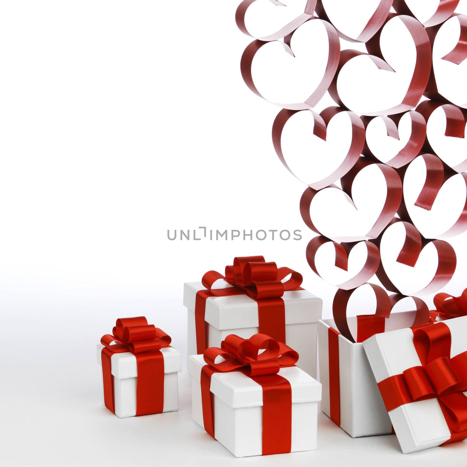 White boxes with red ribbons and decorative hearts isolated on white background