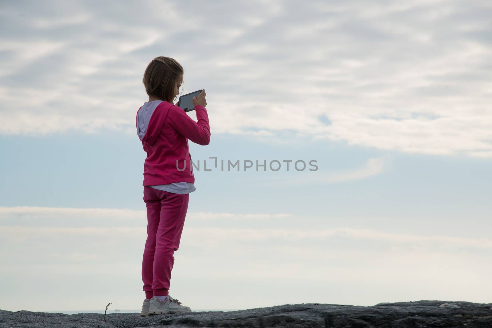 little girl with tablet photographer intent on photographing