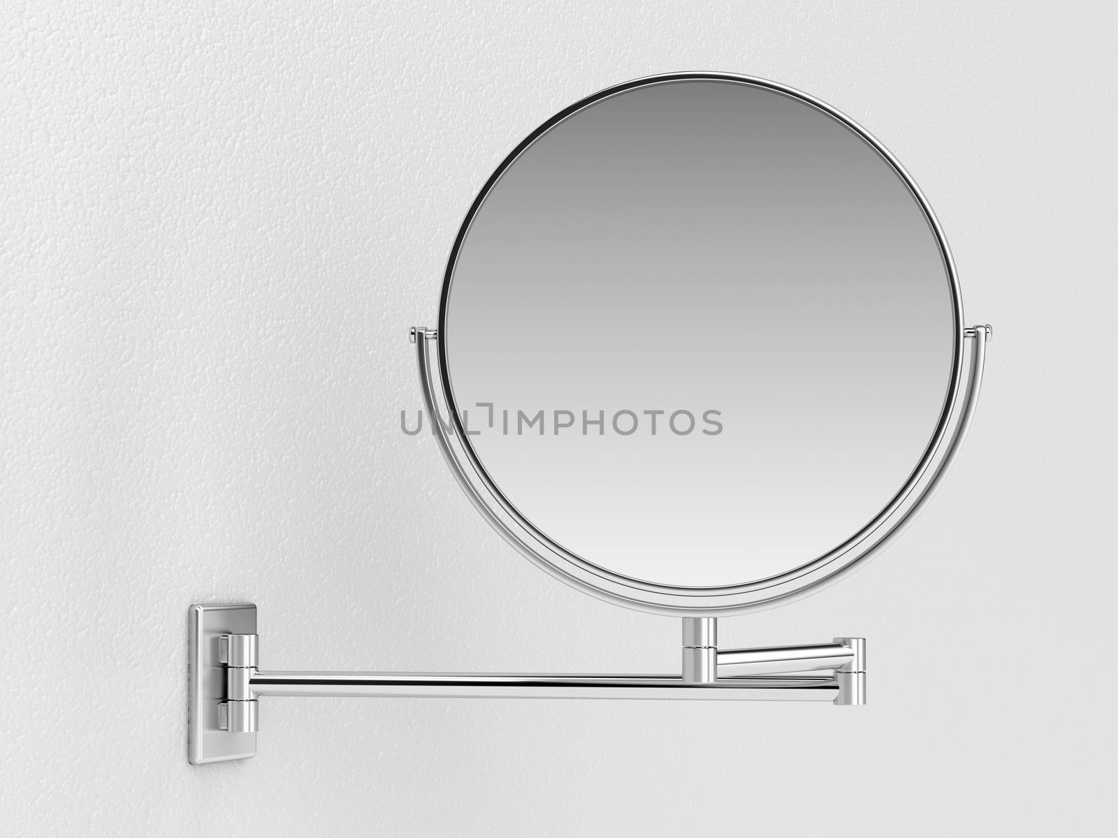 Silver makeup mirror on white wall 