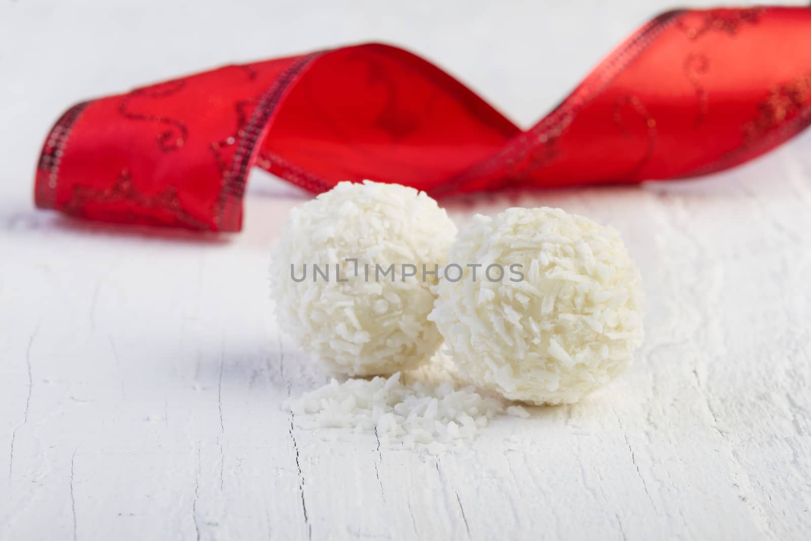 Coconut snowball truffles on white background. Arrangement of coconut cookies on wooden elegant background.